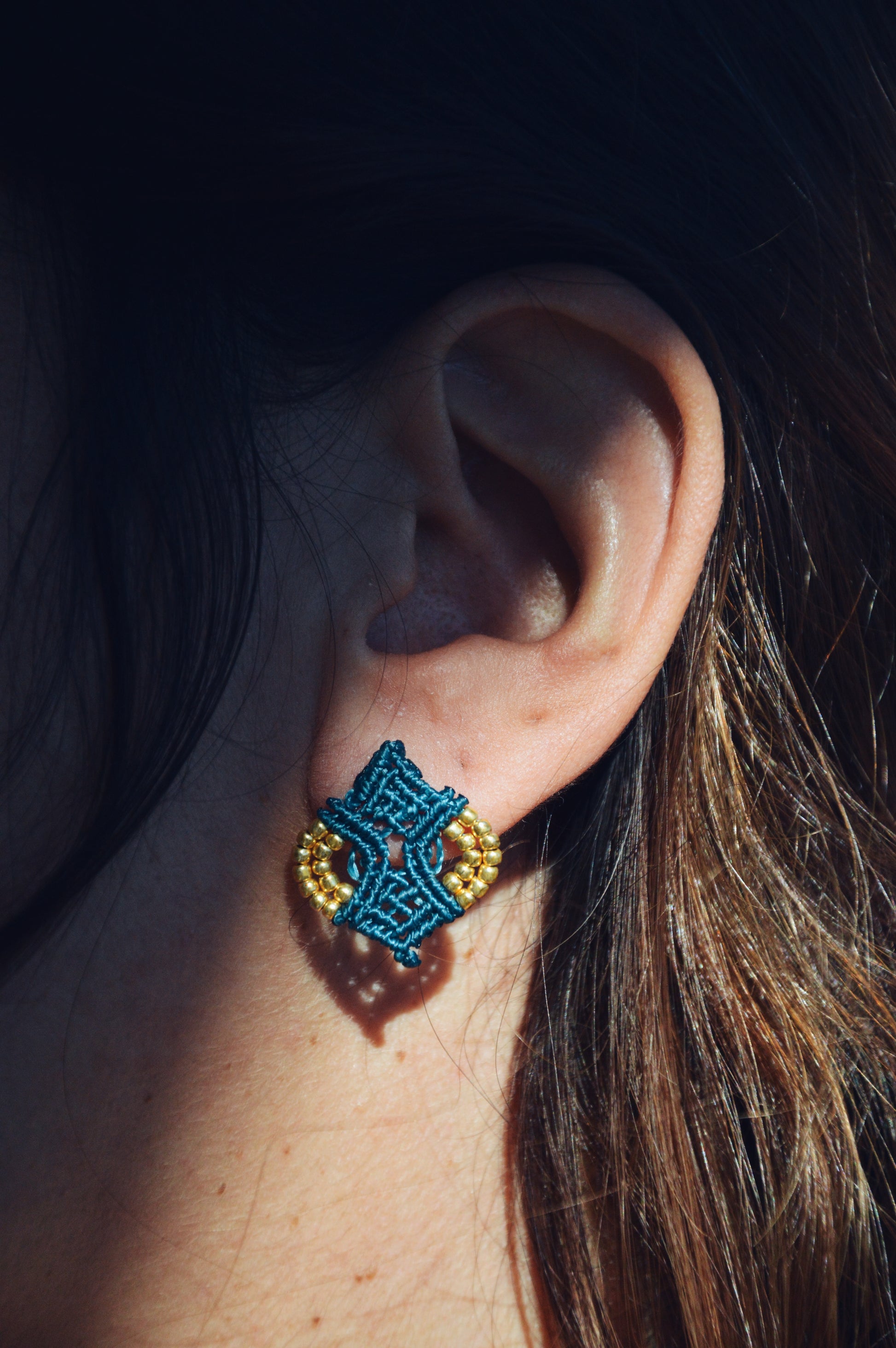 Girl wearing Handmade macrame stud earrings with gold beads